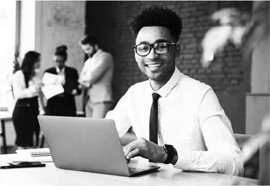 Smiling man working on a laptop